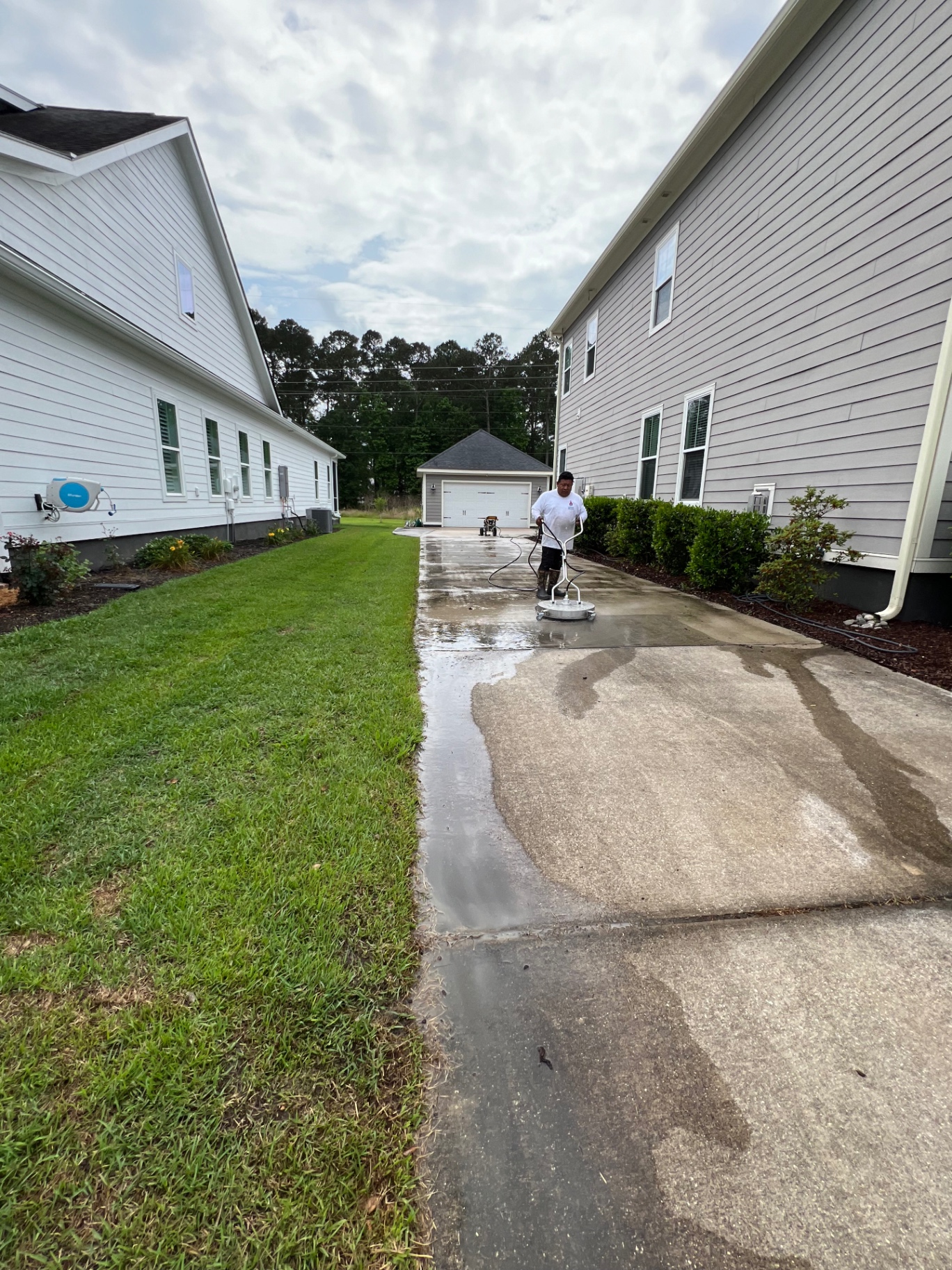 Surface cleaner in action on concrete driveway