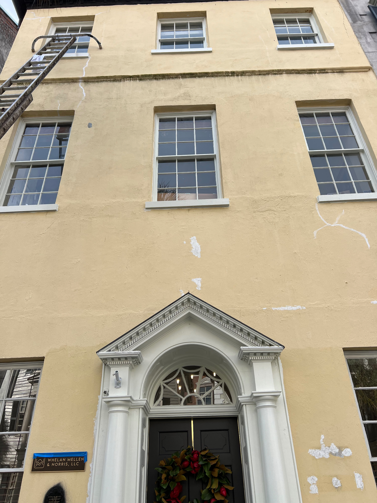 Stucco facade — before repairs and paint