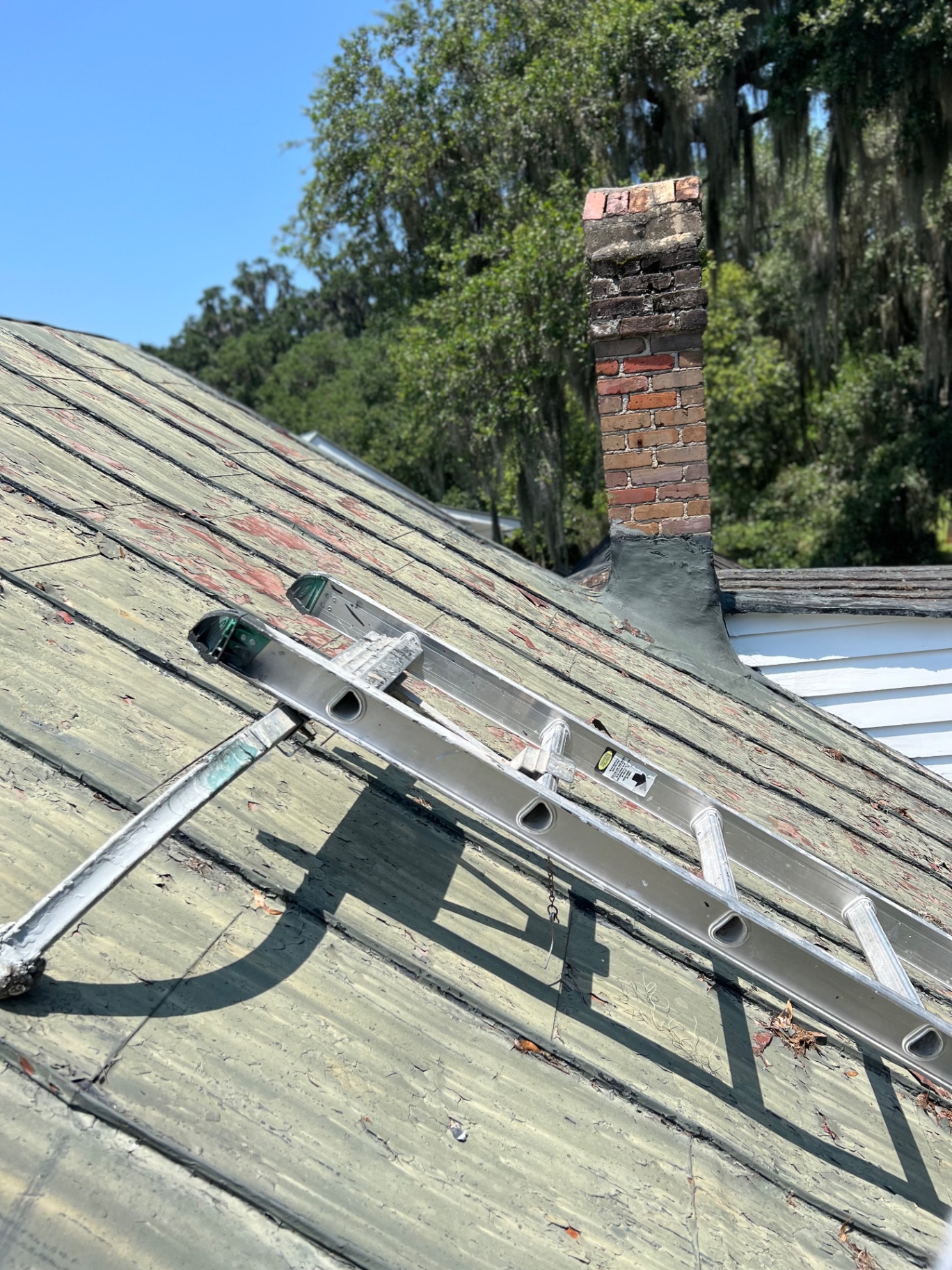 Weathered metal roof — before