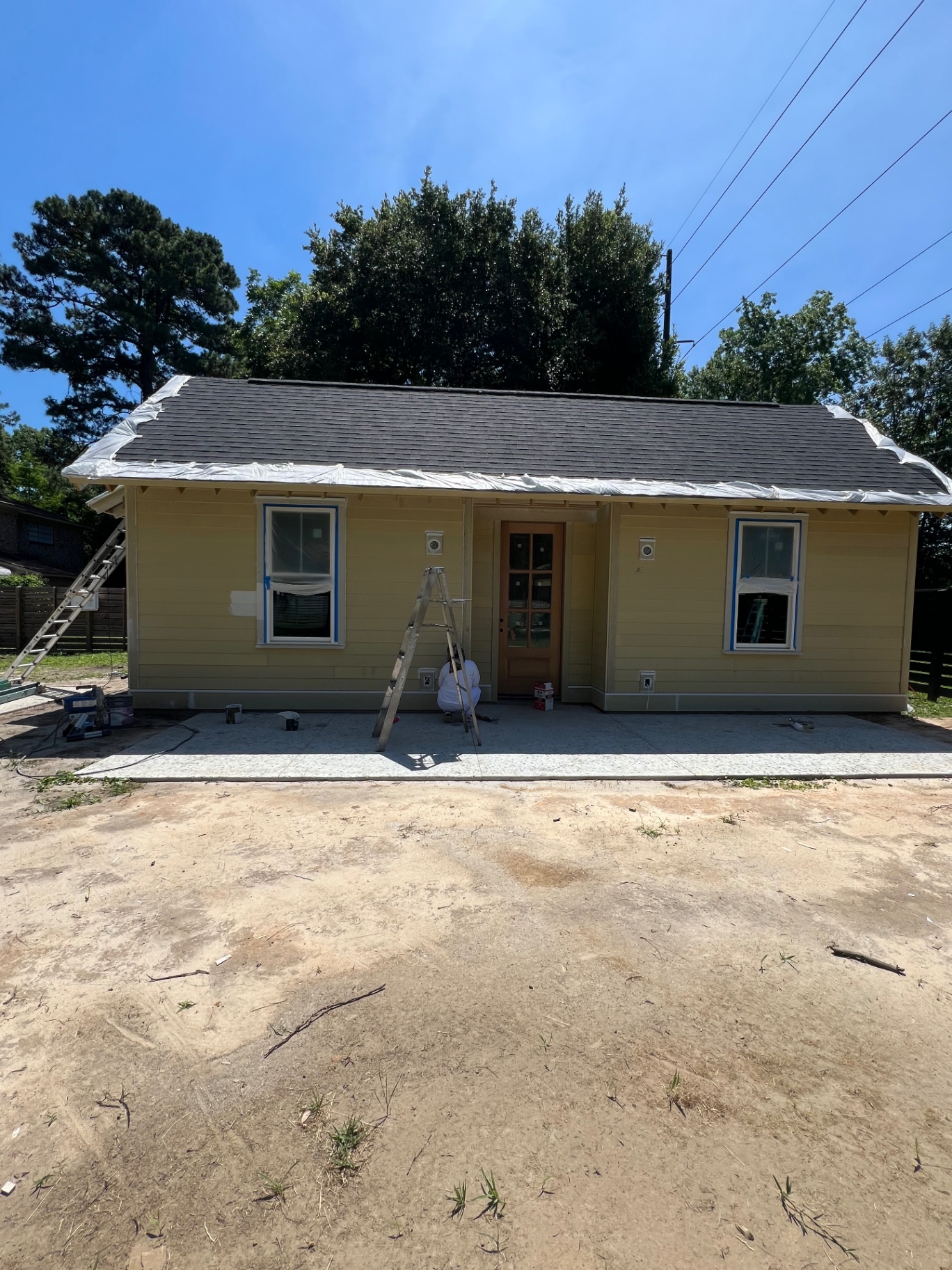 Yellow cottage exterior — fresh coat with mahogany door