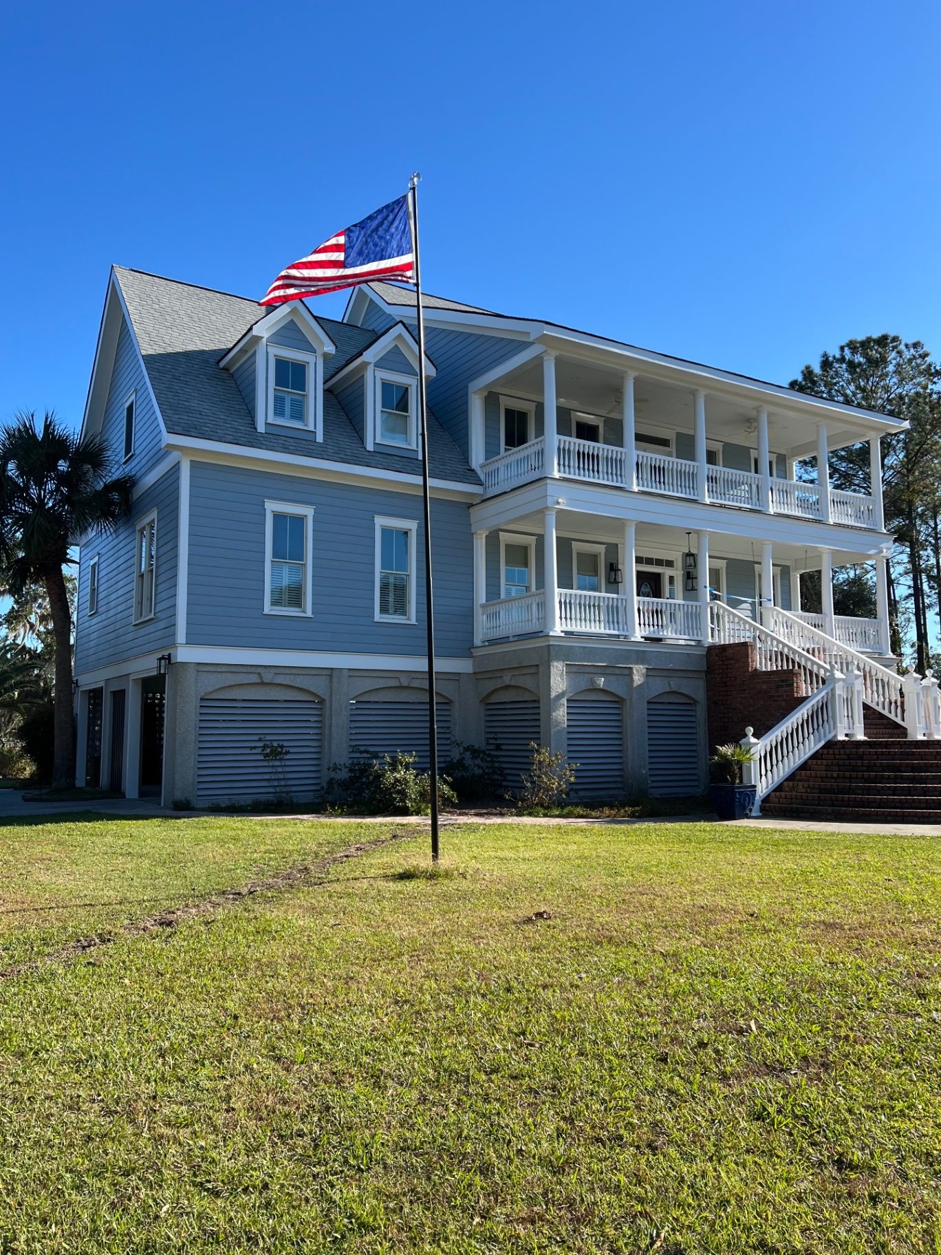 Coastal estate repaint — finished soft blue exterior
